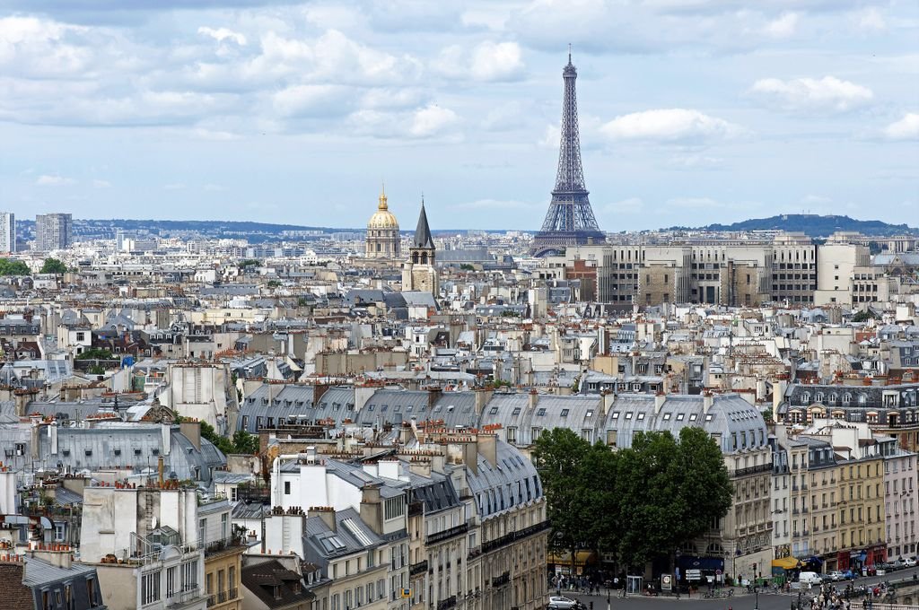 Stunning aerial shot of Paris cityscape featuring the iconic Eiffel Tower and historic architecture.