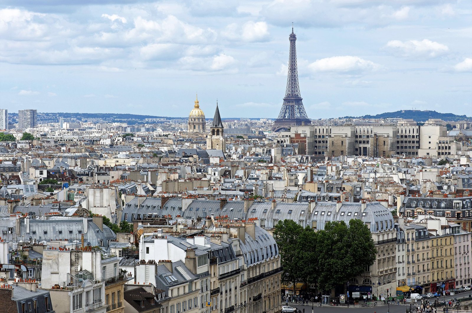Stunning aerial shot of Paris cityscape featuring the iconic Eiffel Tower and historic architecture.